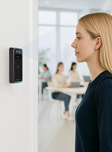 Woman using facial recognition to unlock secure office door with Suprema BioStar Air BioStation 3 reader